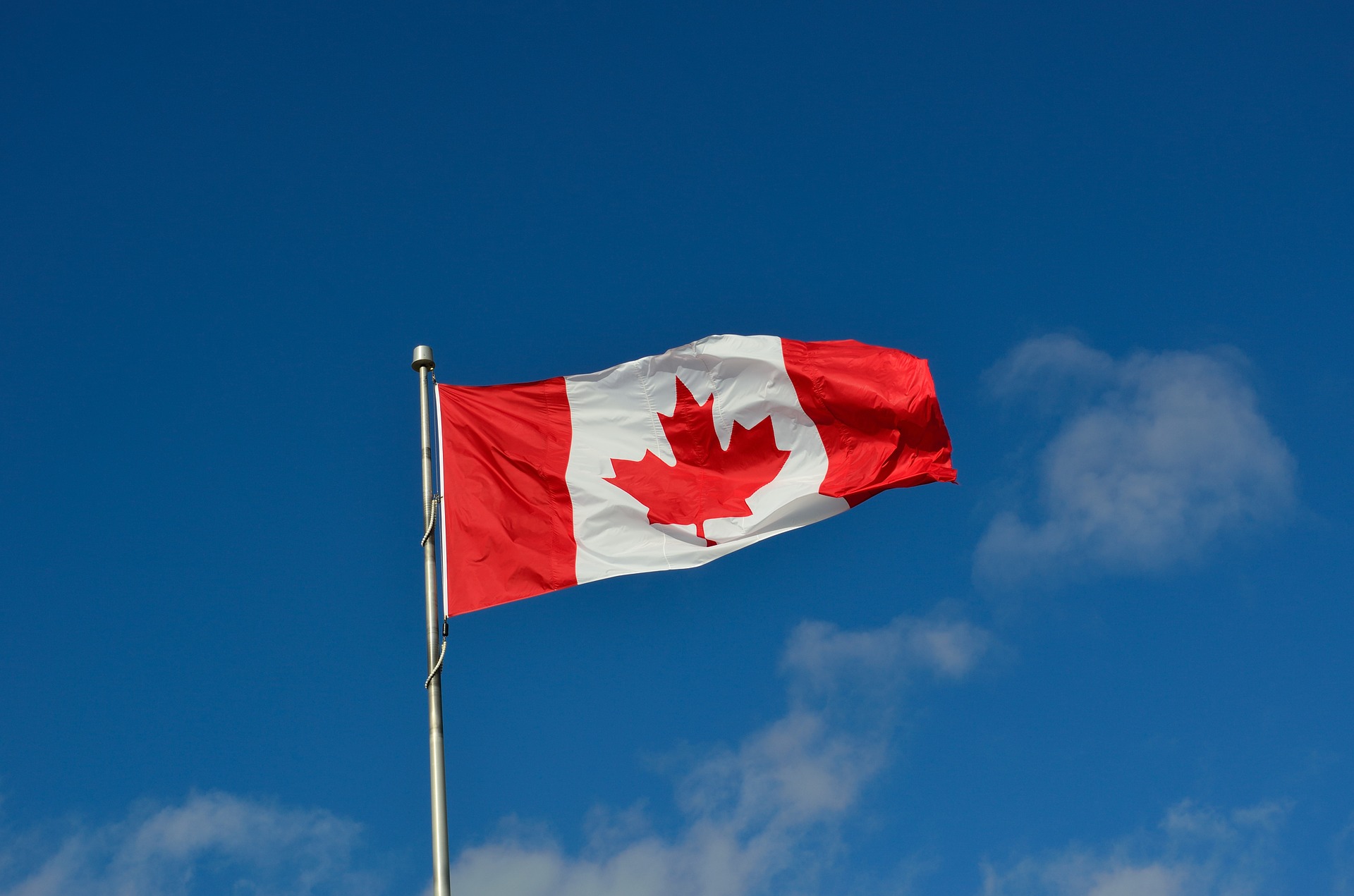 a Canadian flag against a blue sky