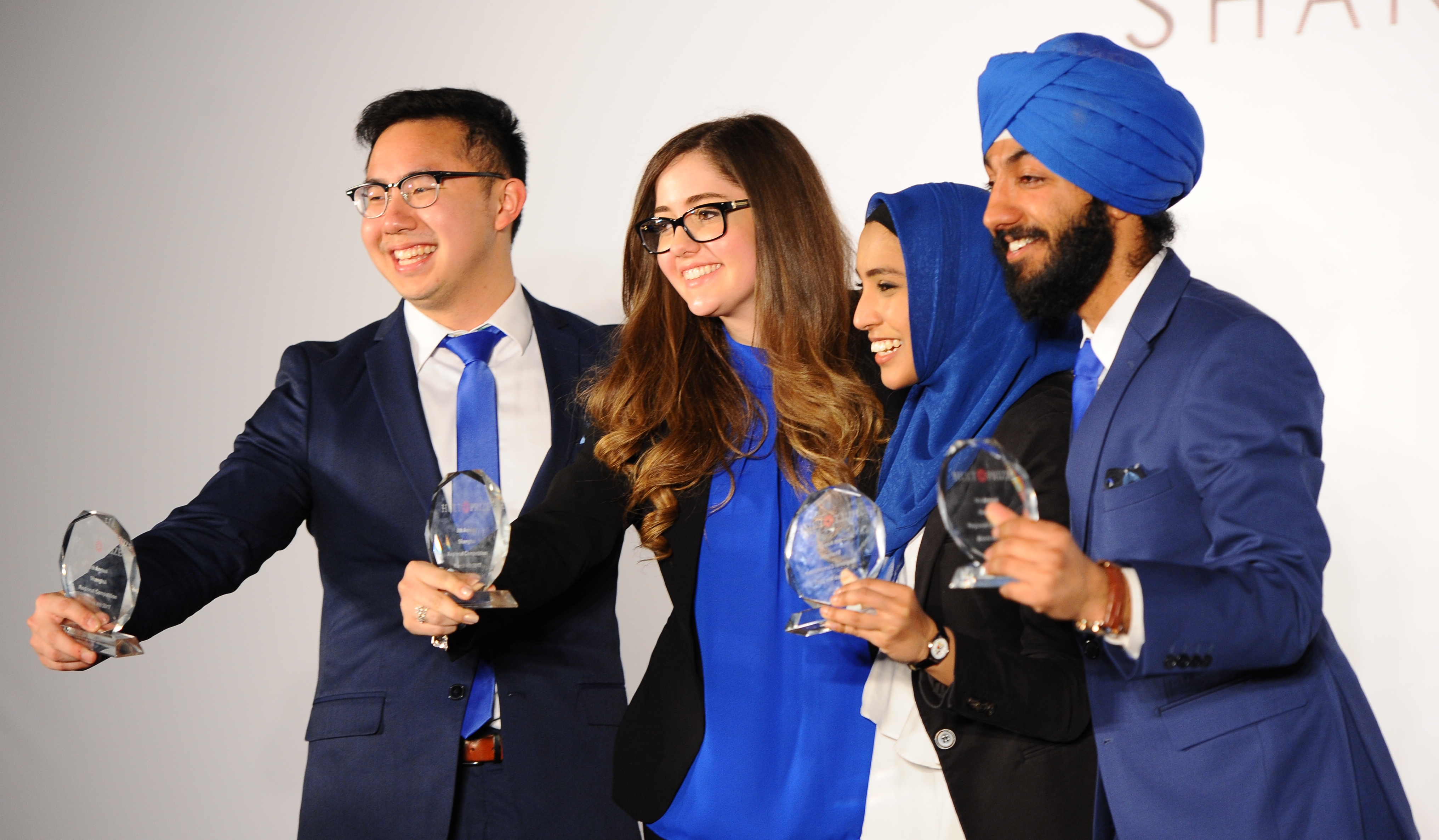 Four members of Team Empower holding Hult Prize Regional Finals trophies