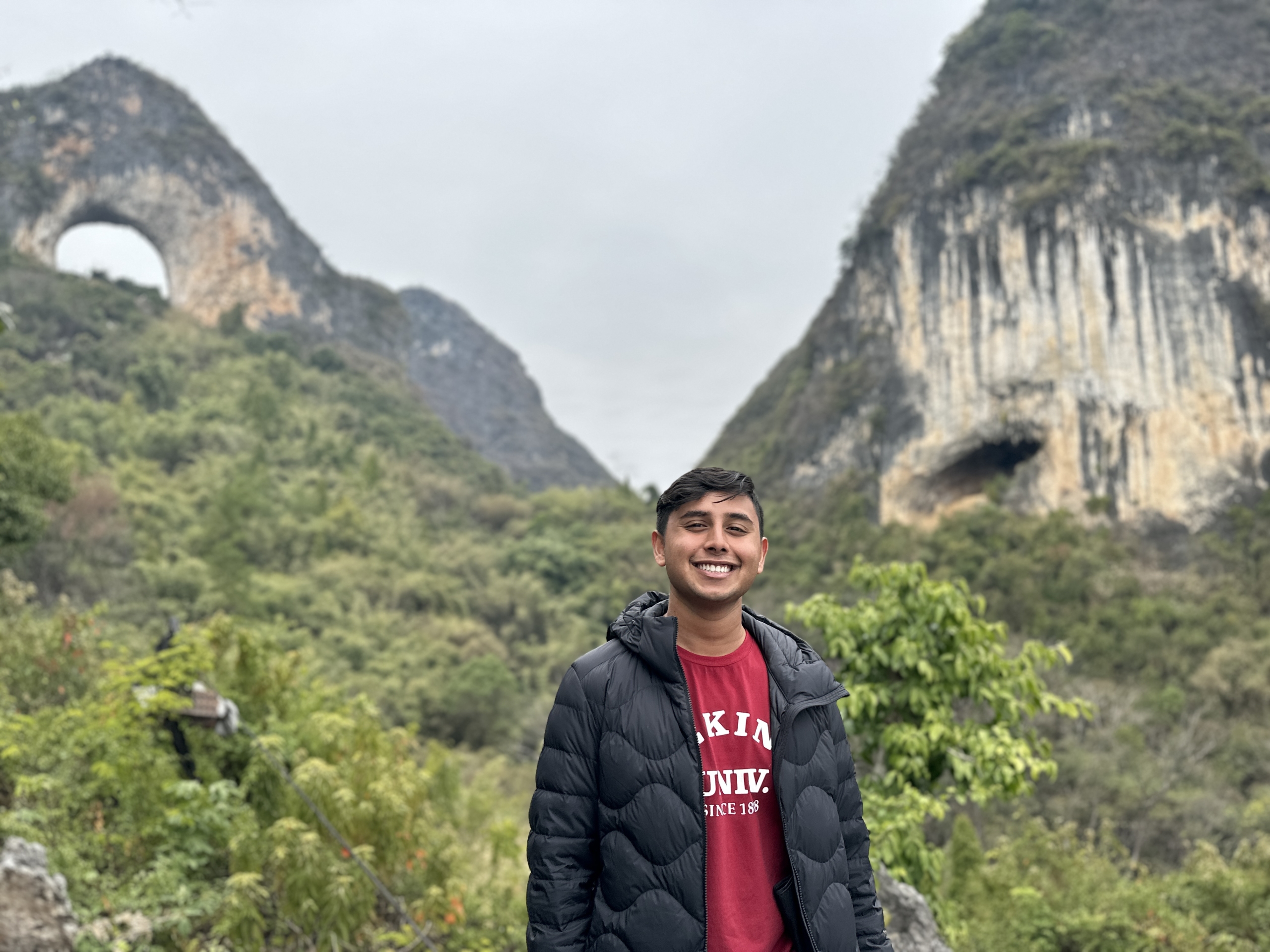 Rynel Pinto standing in front of mountains while studying in China
